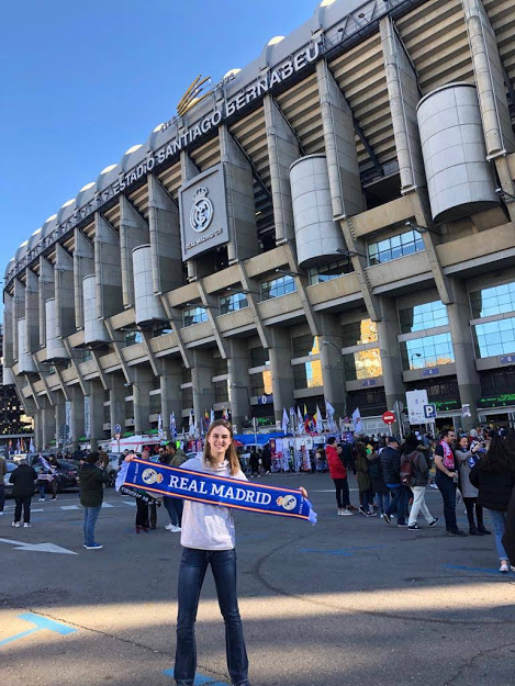 Student posing in front of the real madrid stadium