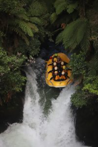 students in raft falling down waterfall in New Zealand 